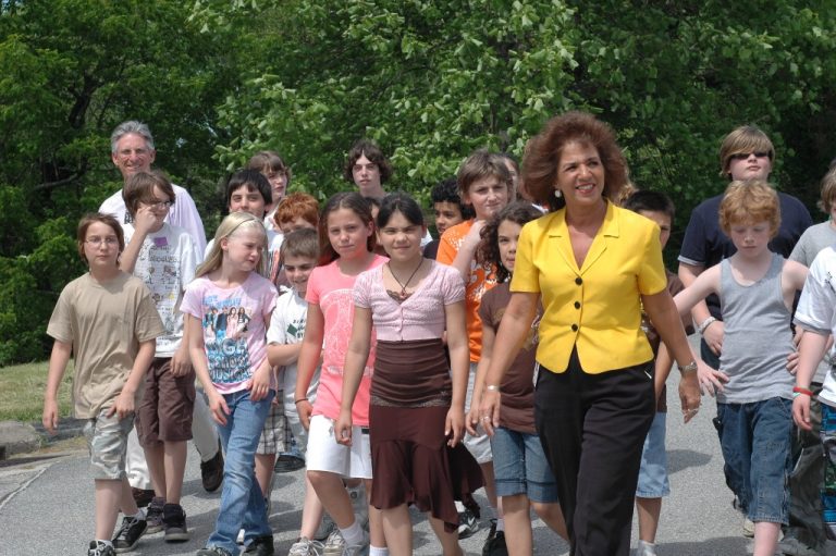 principal walking with students